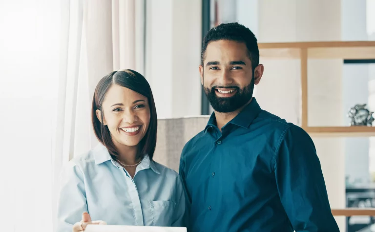 Smiling couple meeting a financial adviser